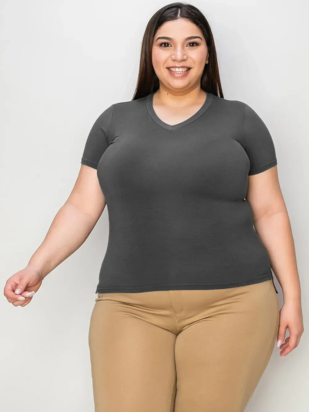Smiling woman wearing a fitted short sleeve gray V-neck t-shirt and beige pants