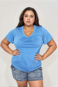 Woman modeling a blue V-neck short sleeve top and denim shorts, casual plus size outfit