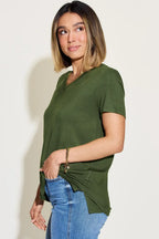 Woman wearing olive green short sleeve V-neck t-shirt and blue jeans