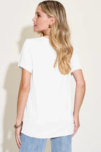 Woman wearing a plain white short sleeve t-shirt and light blue jeans, back view