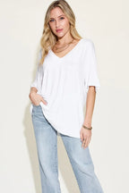 Woman in white V-neck oversized t-shirt and light blue jeans, casual fashion outfit