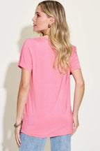 Woman wearing a casual pink short sleeve t-shirt with light blue jeans, back view