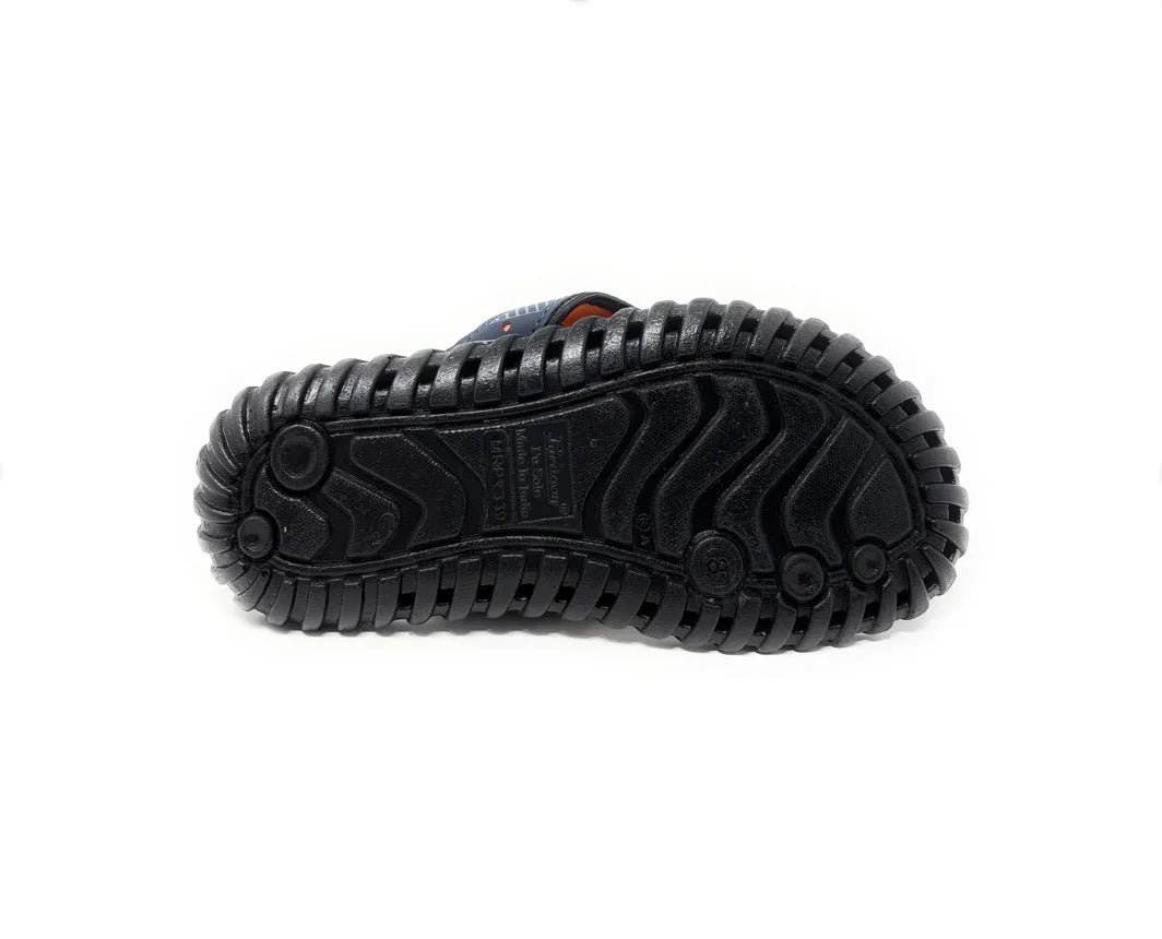 Black rubber sole of a sandal with rugged tread pattern on a white background