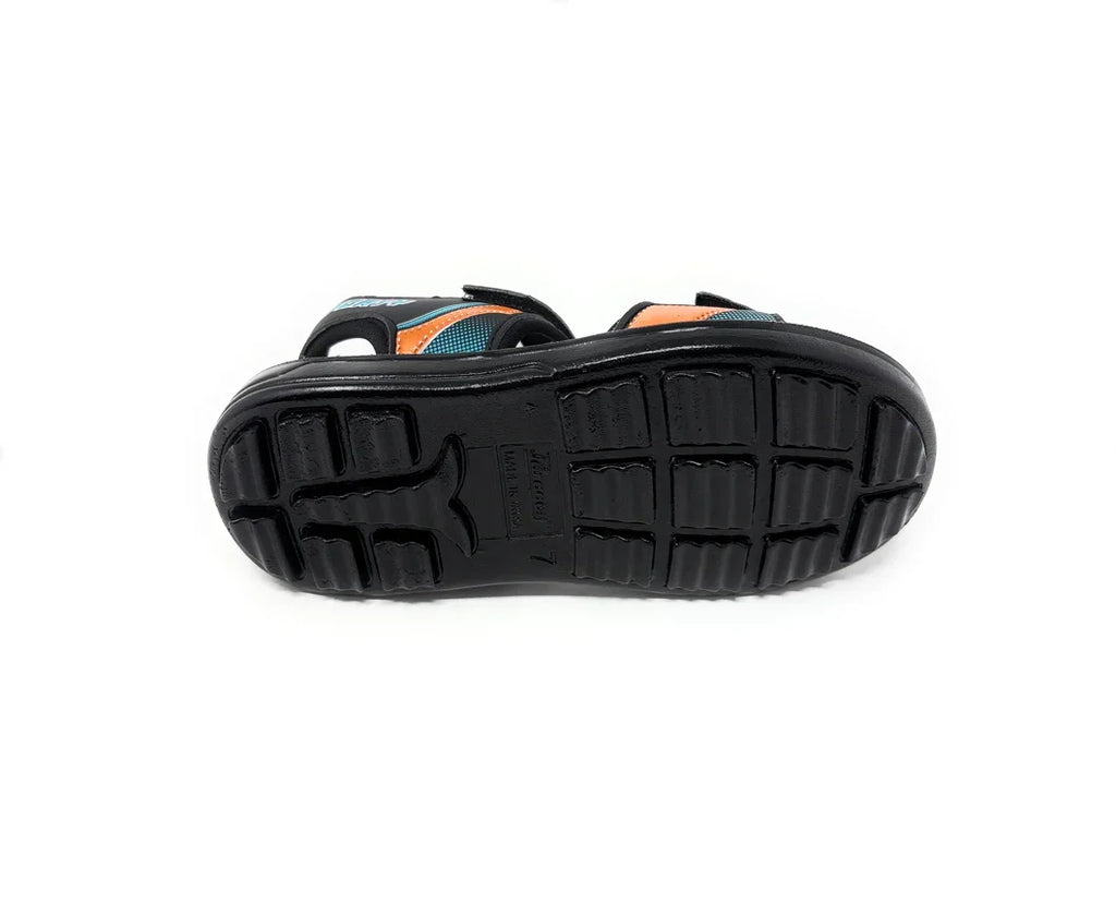 Black rubber sole of a kids sandal with textured grip, blue and orange strap visible