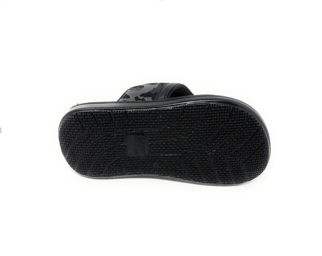 Black slide sandal with textured non-slip sole and camo strap, footwear on white background