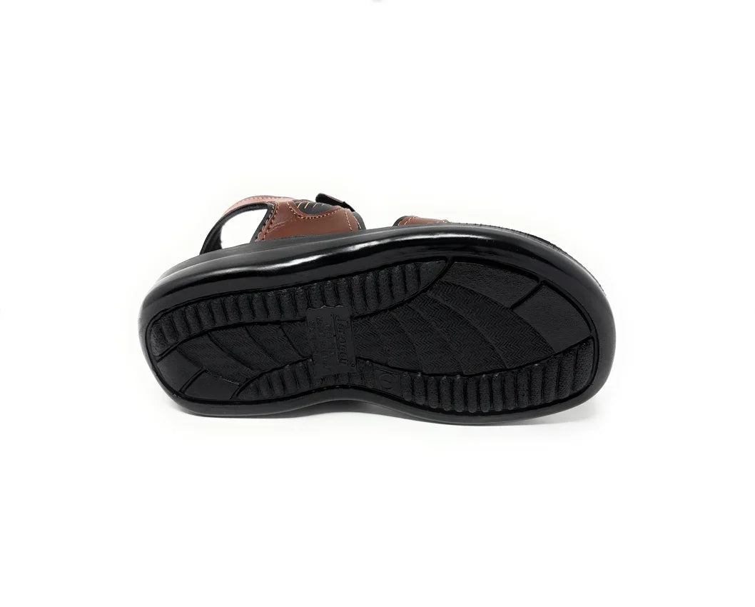Non-slip black rubber sole of a brown sandal, close-up on white background