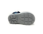 Close-up of a gray non-slip rubber sandal sole with tread pattern on white background