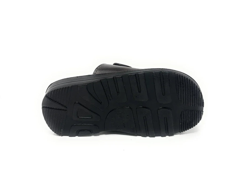 Black shoe with textured rubber sole, non-slip grip, isolated on white background