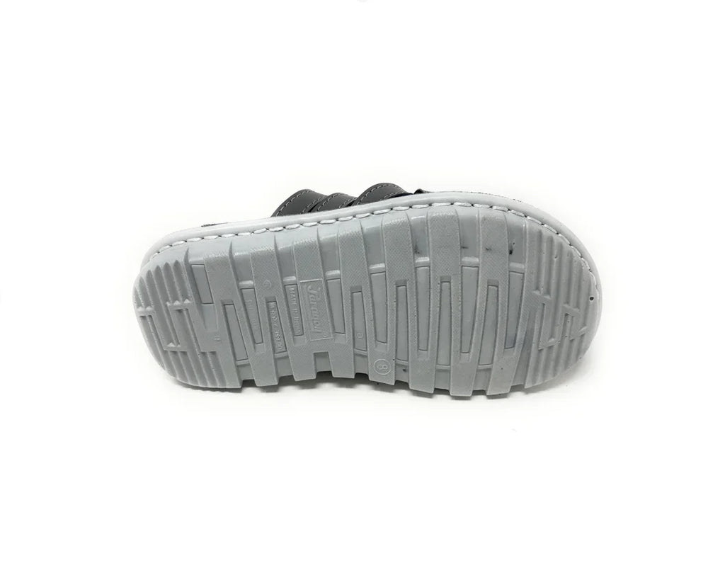 Gray rubber shoe sole with textured tread pattern, isolated on white background