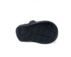 Black shoe with non-slip rubber sole, bottom view on white background