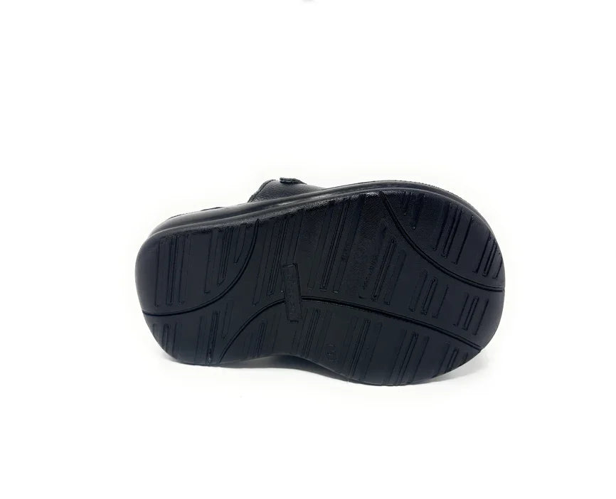 Black shoe with non-slip rubber sole, bottom view on white background