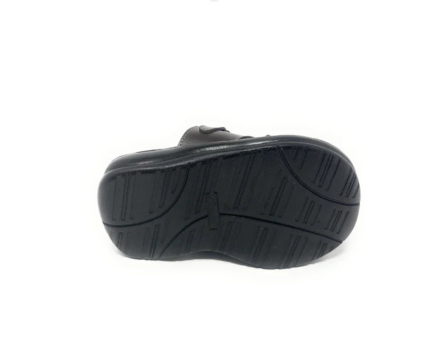 Black shoe with textured non-slip rubber sole, displayed soles up on white background