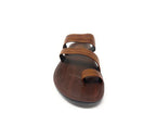 Brown leather flat sandal with triple straps, front view on white background