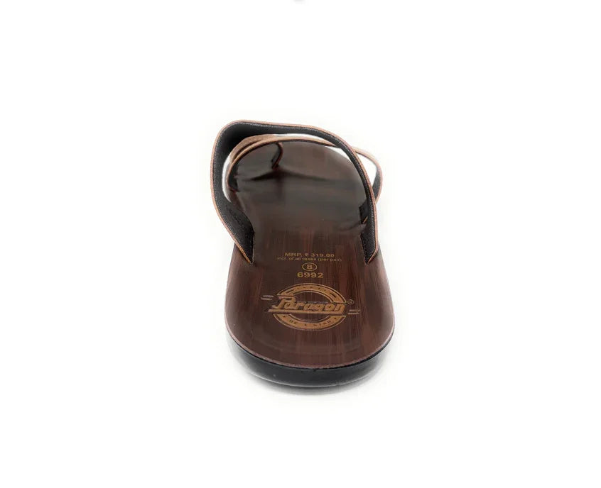 Brown wooden sandal with toe loop and engraved sole on white background