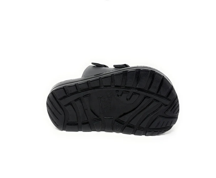 Close-up of a black shoe sole with textured, non-slip grip pattern on white background