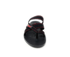 Black and red strappy sandal with open toe, flat sole, and adjustable straps on white background