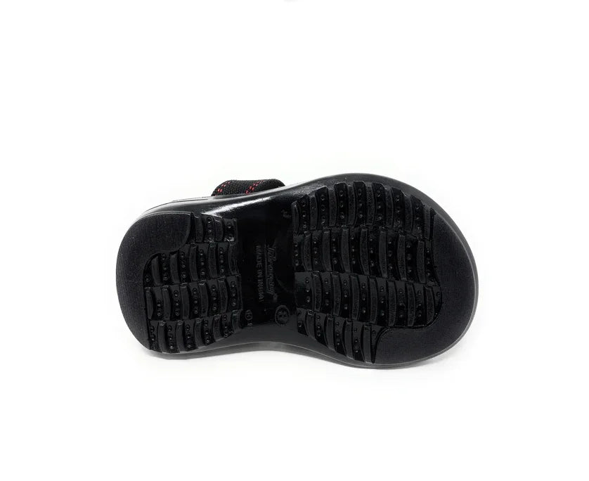 Black rubber shoe sole with textured tread for grip, photographed on a white background