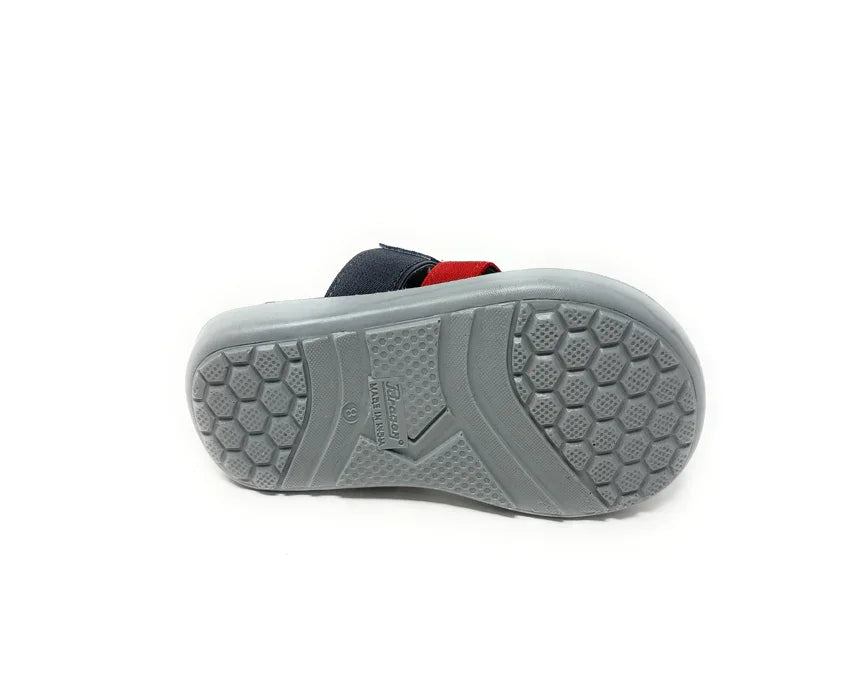 Gray rubber sandal sole with honeycomb tread pattern, navy and red strap visible on top