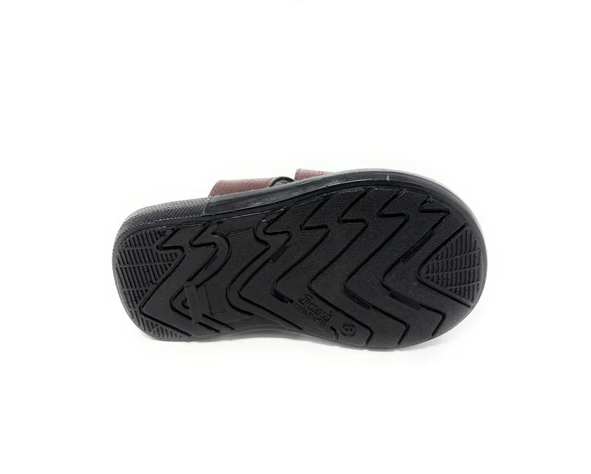 Close-up of black sandal sole with textured grip tread, isolated on white background