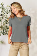 Woman wearing casual grey short sleeve t-shirt with layered gold necklaces