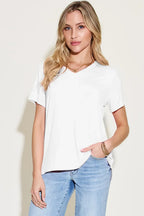 Woman wearing a casual white V-neck t-shirt and light blue jeans